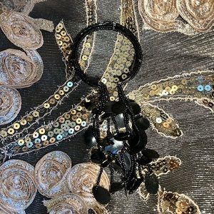 Interesting black beaded bracelet with long tassels